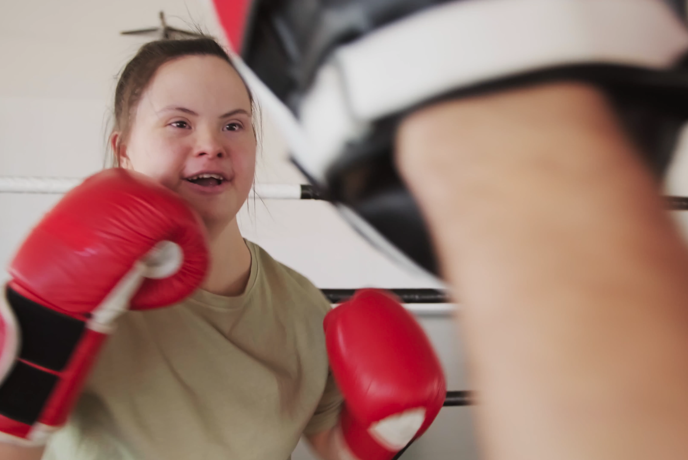 Girl with Downs Syndrome boxing and smiling